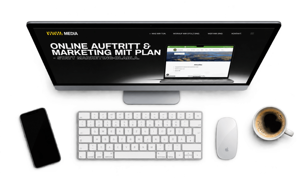 Webseite von wiwamedia auf einem iMac mit Tastatur, Maus, Smartphone und Kaffee